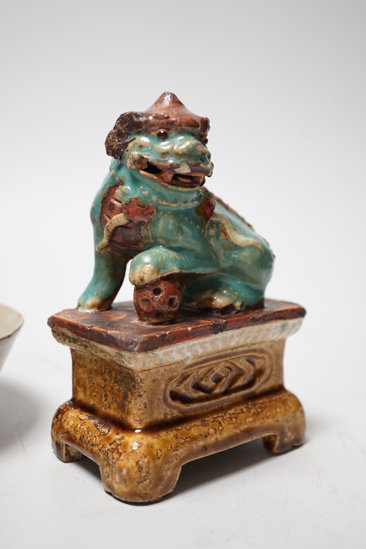 A 19th century Chinese Shiwan figure of a lion-dog and celadon glazed shallow bowl. Tallest 14cm